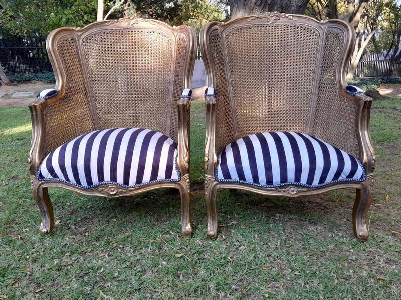 A Pair of 20th Century French Style Gilt Wood Arm Chairs with Rattan Back