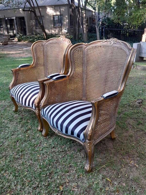 A Pair of 20th Century French Style Gilt Wood Arm Chairs with Rattan Back