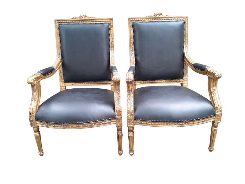 A 20th Century French Style Pair of Carved Gilt-Wood Arm Chairs Upholstered in Black Leather