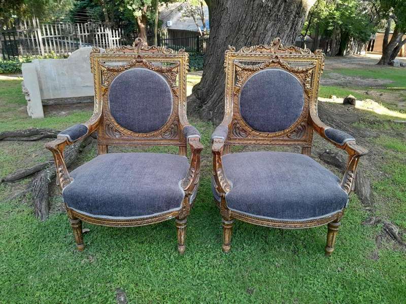 A Pair Of 20th Century French Style Ornately Carved Gilt Wood Arm Chairs