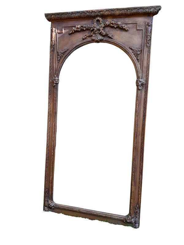 A French Style Ornately Carved And Gilded Bevelled Mirror Of Large Proportions