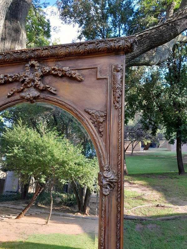 A French Style Ornately Carved And Gilded Bevelled Mirror Of Large Proportions