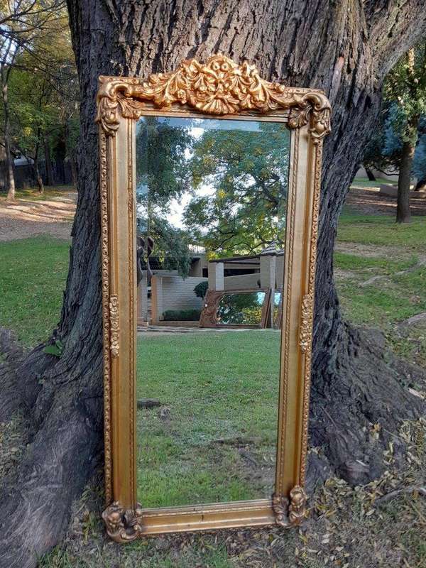 A French Style Ornately Carved and Gilded Bevelled Mirror
