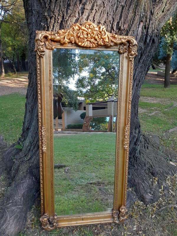 A French Style Ornately Carved and Gilded Bevelled Mirror