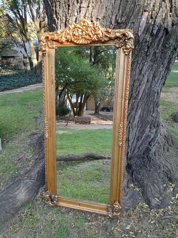A French Style Ornately Carved and Gilded Bevelled Mirror