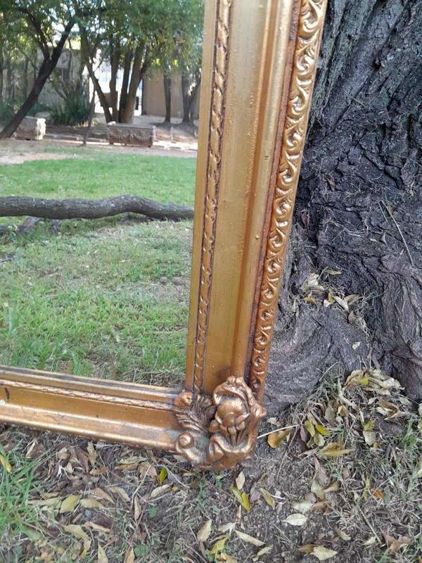 A French Style Ornately Carved and Gilded Bevelled Mirror