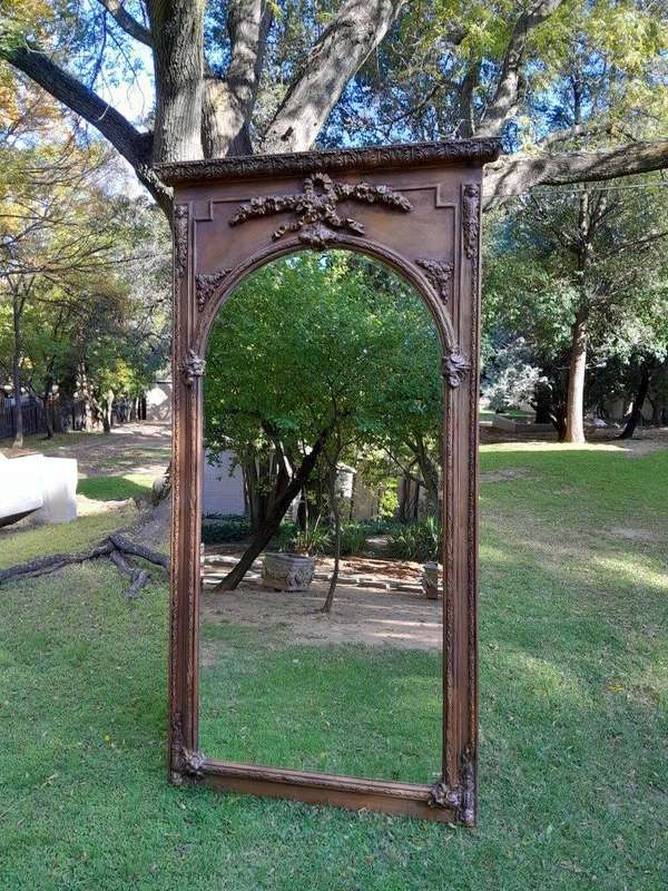 A French Style Ornately Carved and Gilded Bevelled Mirror of Large Proportions