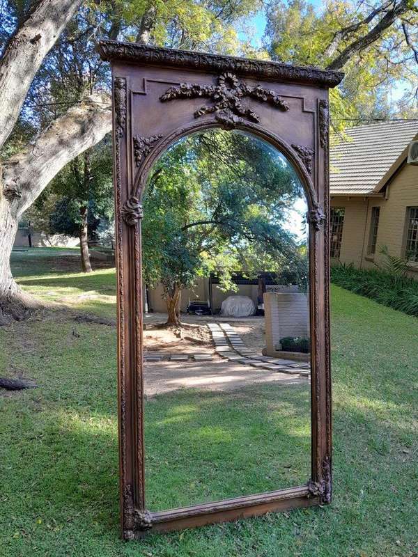 A French Style Ornately Carved and Gilded Bevelled Mirror of Large Proportions