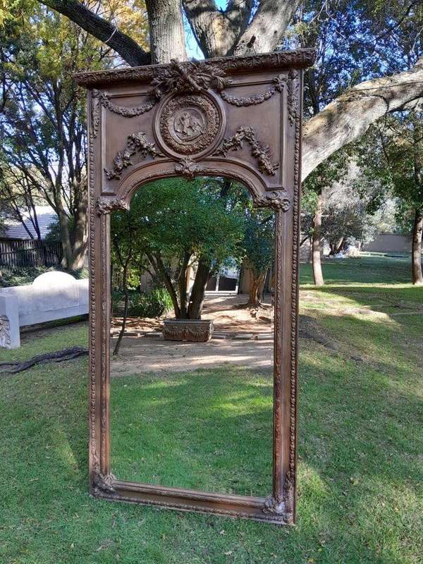 A French Style Ornately Carved and Gilded Bevelled Mirror of Large Proportions