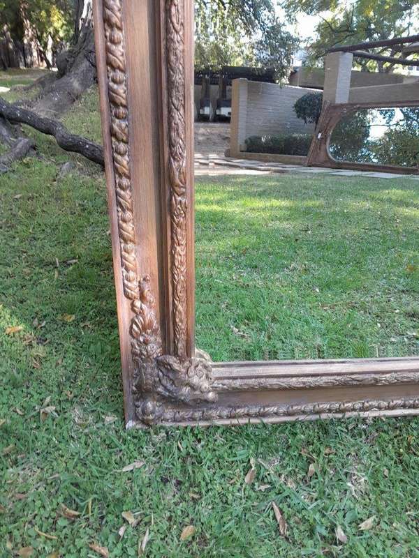A French Style Ornately Carved and Gilded Bevelled Mirror of Large Proportions