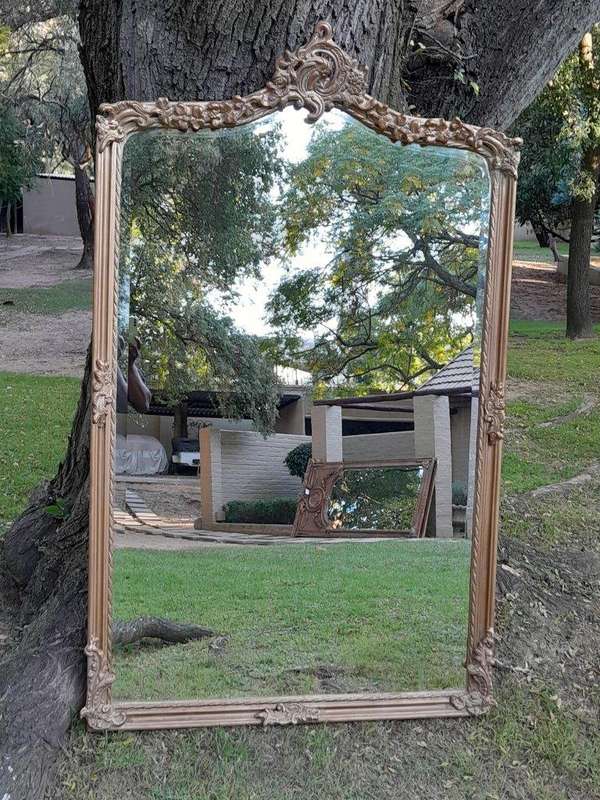 A French Style Ornately Carved and Gilded Bevelled Mirror of Large Proportions