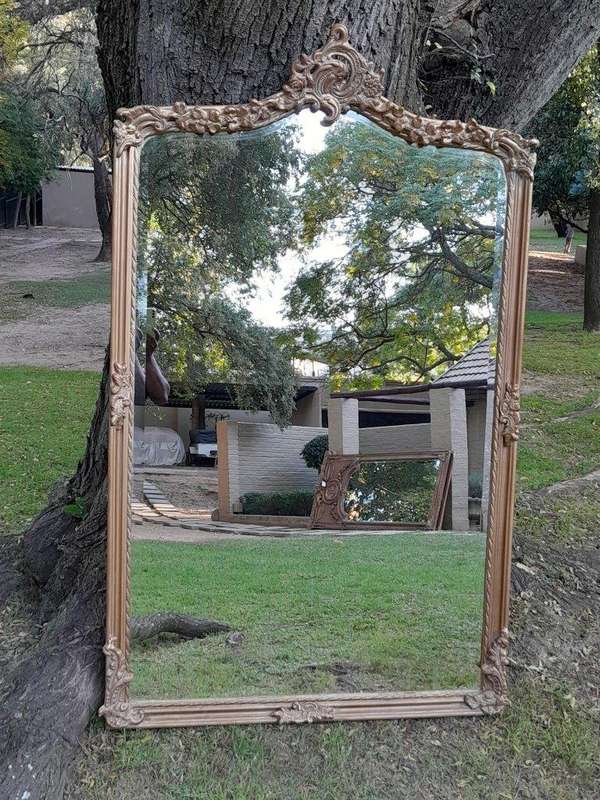 A French Style Ornately Carved and Gilded Bevelled Mirror of Large Proportions