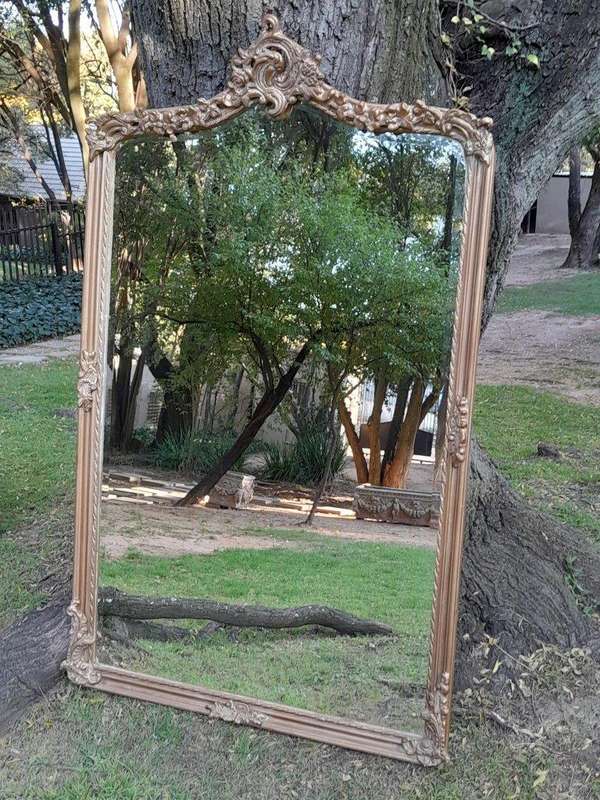 A French Style Ornately Carved and Gilded Bevelled Mirror of Large Proportions