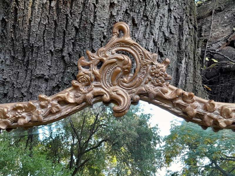 A French Style Ornately Carved and Gilded Bevelled Mirror of Large Proportions