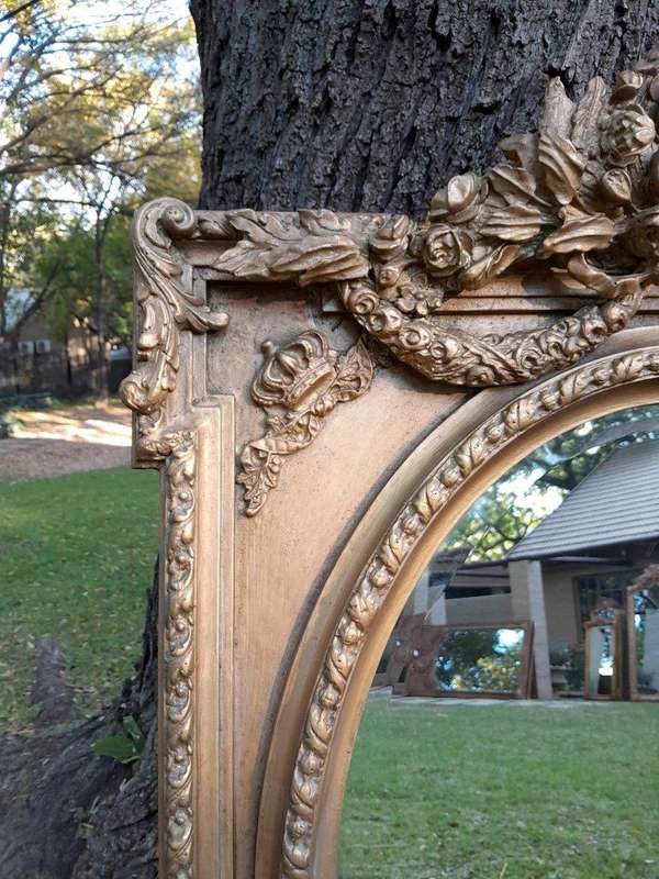 A French Rococo Style Ornately Carved & Gilded Bevelled Mirror