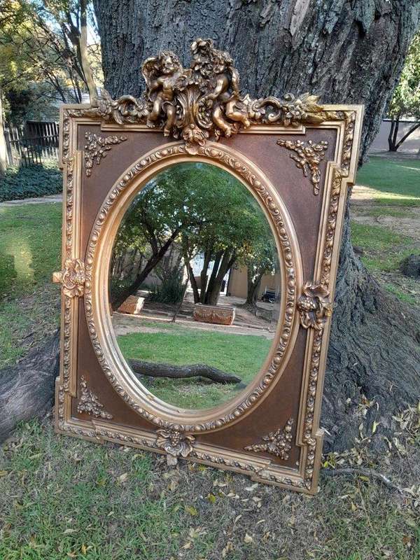 A French Rococo Style Ornately Carved & Gilded Bevelled Mirror