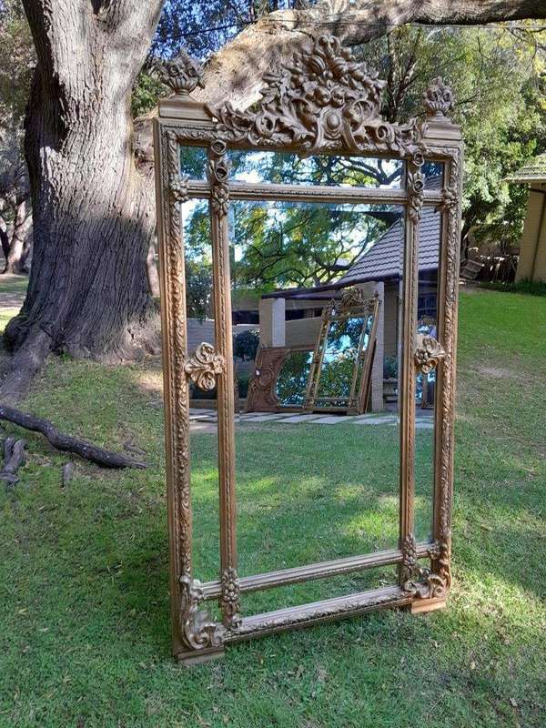 A French Rococo Style Large Ornately Carved & Gilded Bevelled Mirror