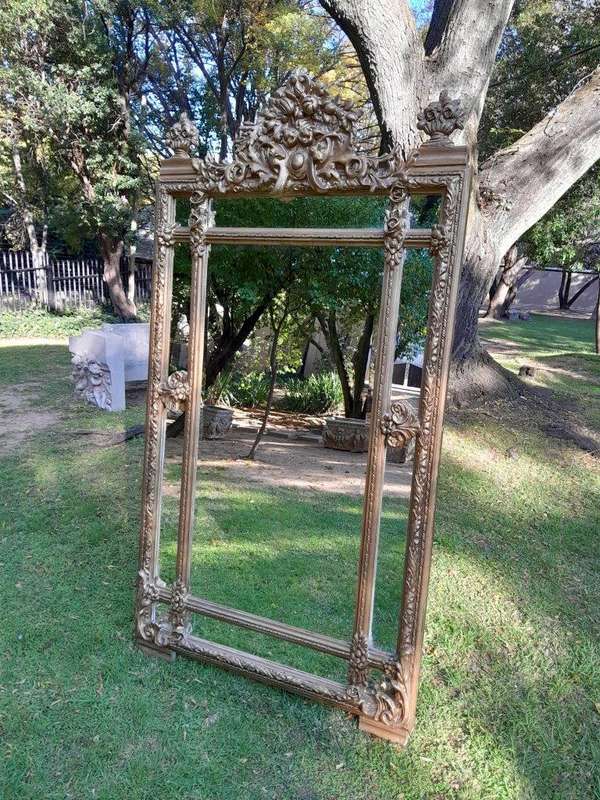 A French Rococo Style Large Ornately Carved & Gilded Bevelled Mirror