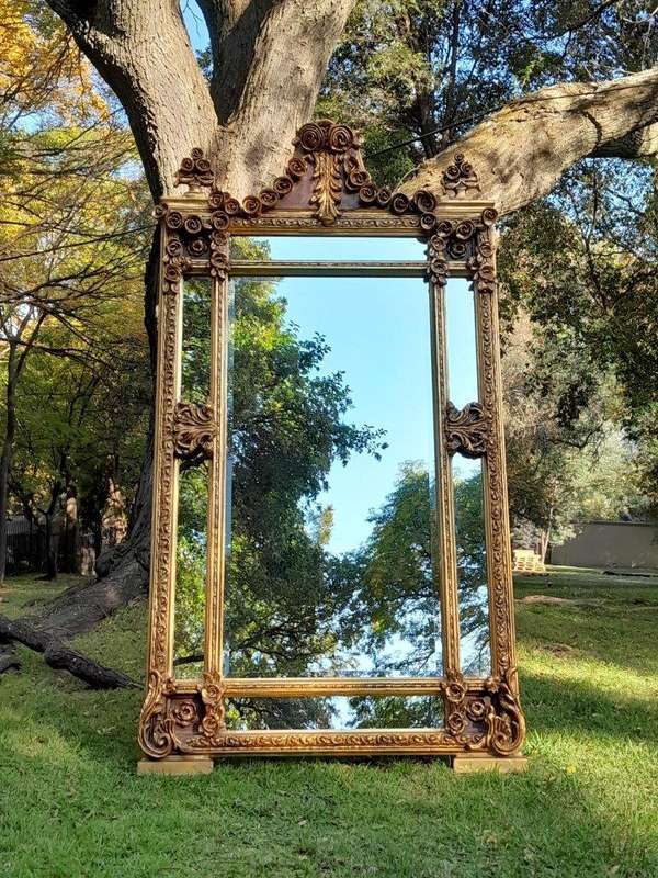 A French Rococo Style Ornately Carved & Gilded Bevelled Mirror