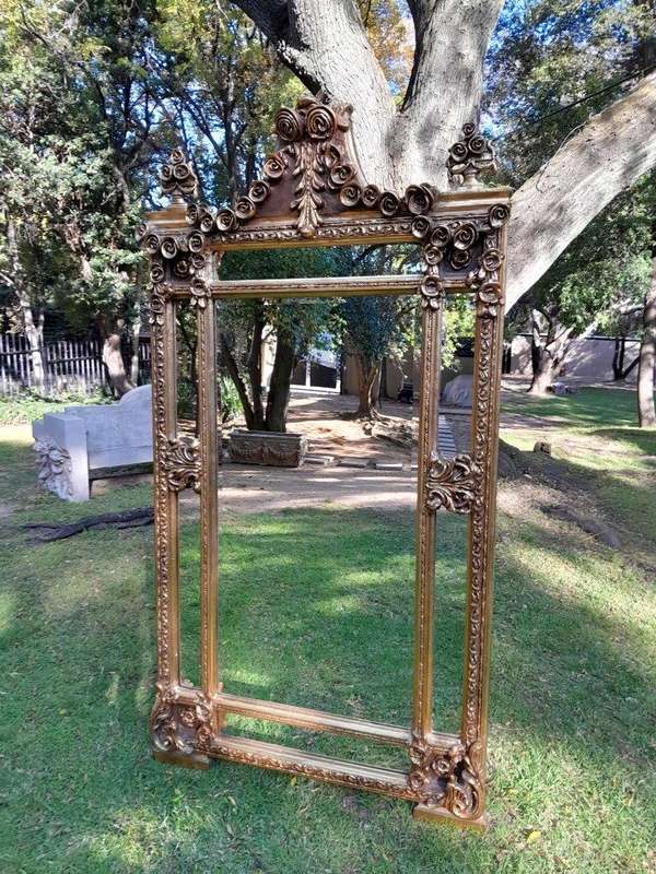 A French Rococo Style Ornately Carved & Gilded Bevelled Mirror