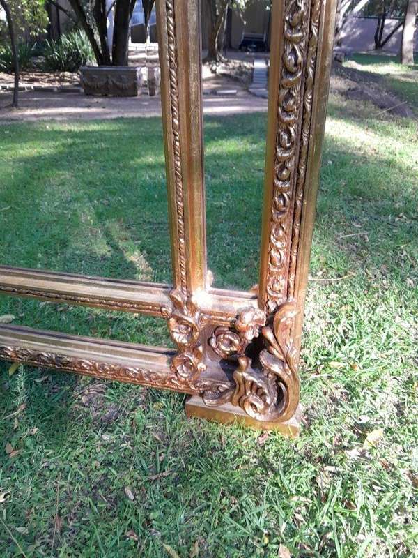 A French Rococo Style Ornately Carved & Gilded Bevelled Mirror