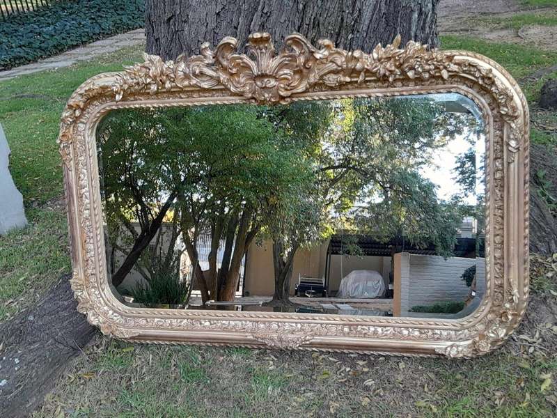 A French Rococo Style Ornately Carved & Gilded Bevelled Mirror