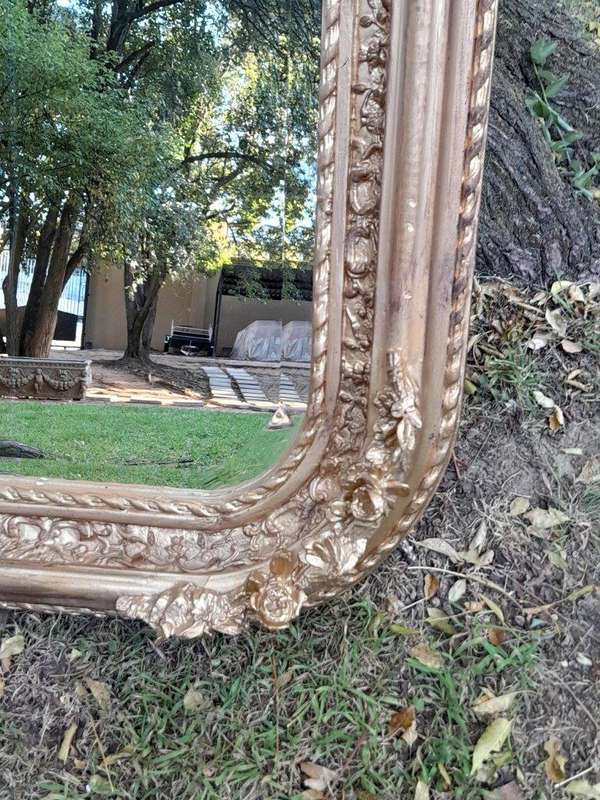 A French Rococo Style Ornately Carved & Gilded Bevelled Mirror