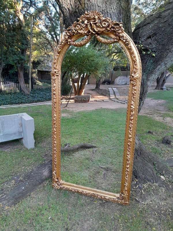 A French Rococo Style Ornately Carved & Gilded Bevelled Mirror