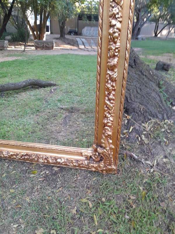 A French Rococo Style Ornately Carved & Gilded Bevelled Mirror