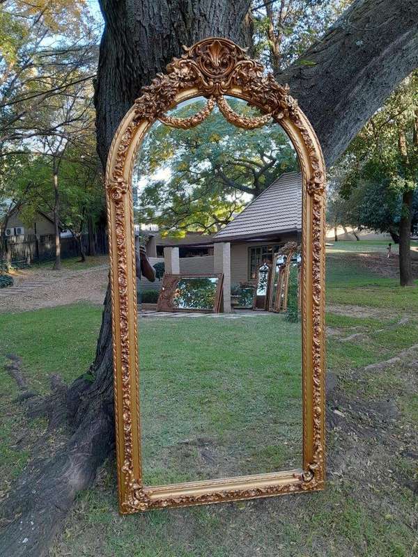 A French Rococo Style Ornately Carved & Gilded Bevelled Mirror
