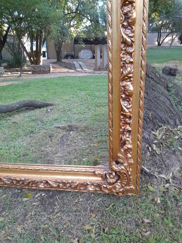 A French Rococo Style Ornately Carved & Gilded Bevelled Mirror