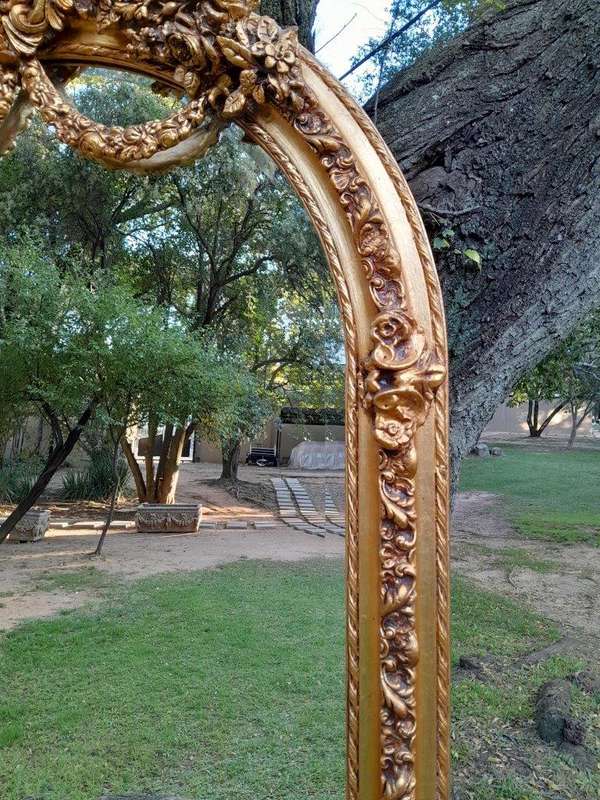 A French Rococo Style Ornately Carved & Gilded Bevelled Mirror