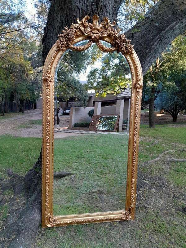 A French Rococo Style Ornately Carved & Gilded Bevelled Mirror