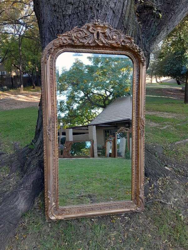A French Rococo Style Ornately Carved & Gilded Bevelled Mirror