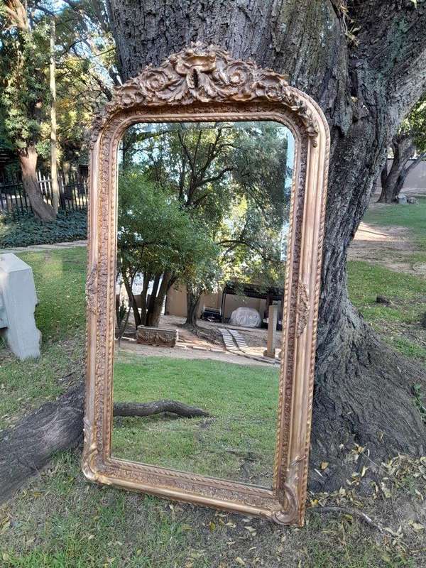 A French Rococo Style Ornately Carved & Gilded Bevelled Mirror