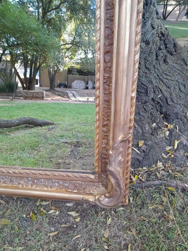A French Rococo Style Ornately Carved & Gilded Bevelled Mirror