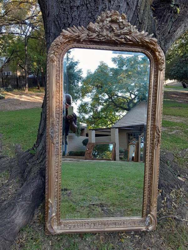 A French Rococo Style Ornately Carved & Gilded Bevelled Mirror