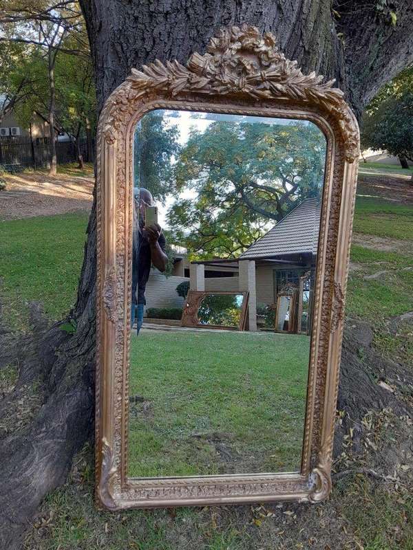 A French Rococo Style Ornately Carved & Gilded Bevelled Mirror
