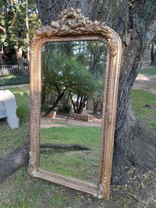 A French Rococo Style Ornately Carved & Gilded Bevelled Mirror
