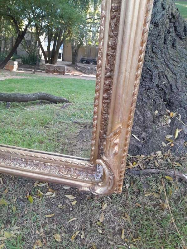 A French Rococo Style Ornately Carved & Gilded Bevelled Mirror