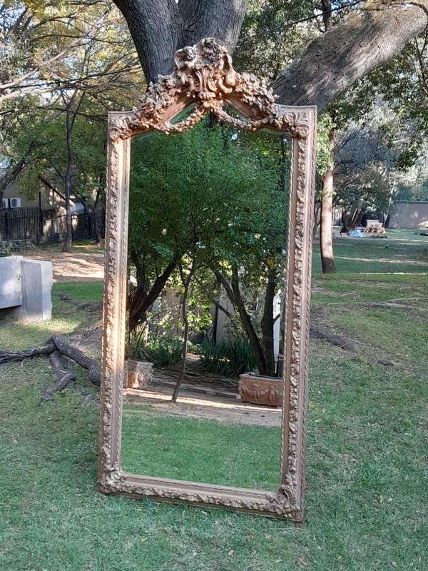 A French Rococo Style Ornately Carved & Gilded Bevelled Mirror