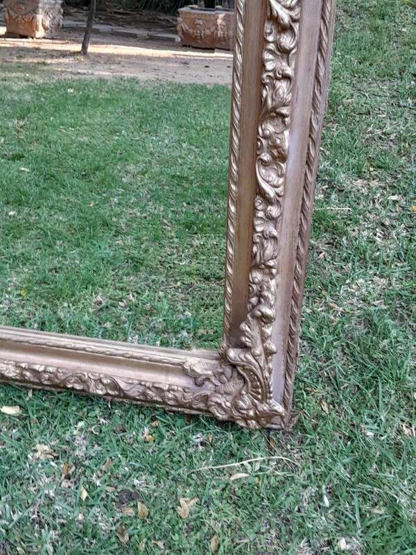 A French Rococo Style Ornately Carved & Gilded Bevelled Mirror