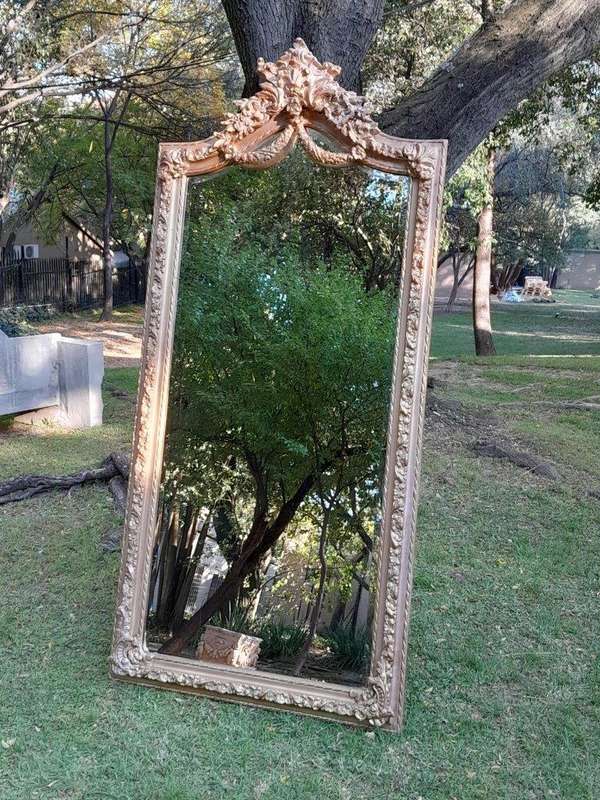 A French Rococo Style Ornately Carved & Gilded Bevelled Mirror
