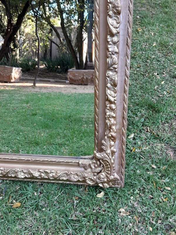 A French Rococo Style Ornately Carved & Gilded Bevelled Mirror