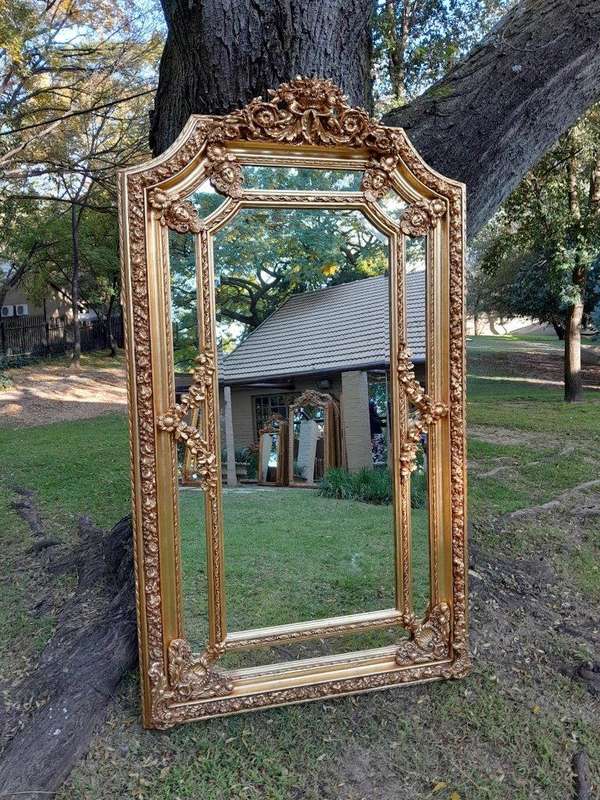 A French Rococo Style Ornately Carved & Gilded Bevelled Mirror