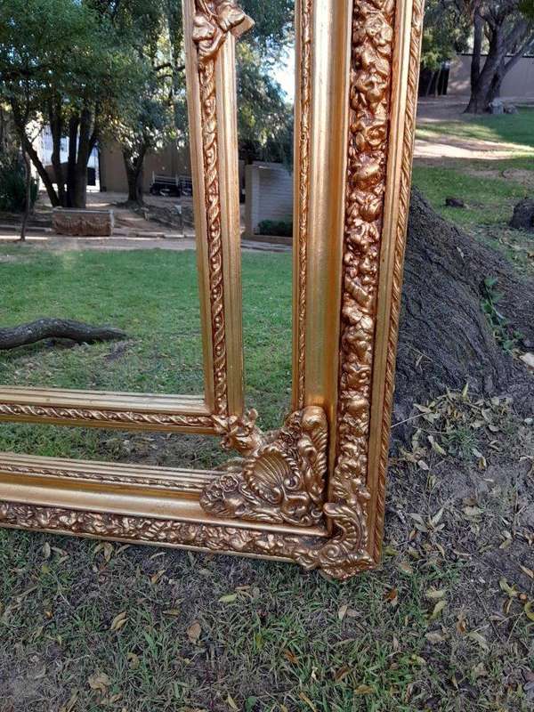 A French Rococo Style Ornately Carved & Gilded Bevelled Mirror