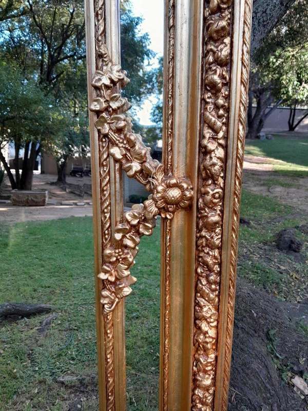 A French Rococo Style Ornately Carved & Gilded Bevelled Mirror