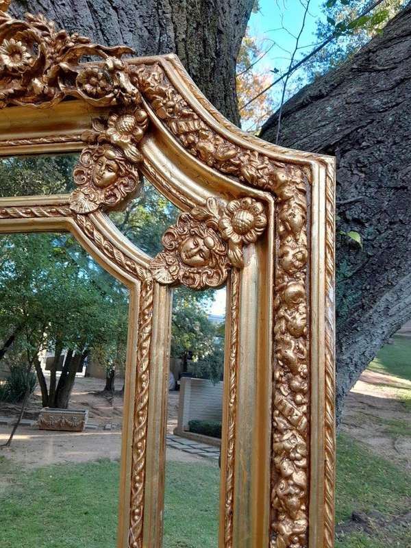A French Rococo Style Ornately Carved & Gilded Bevelled Mirror