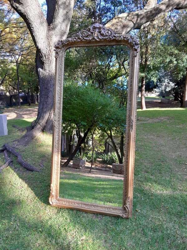 A French Rococo Style Ornately Carved & Gilded Bevelled Mirror