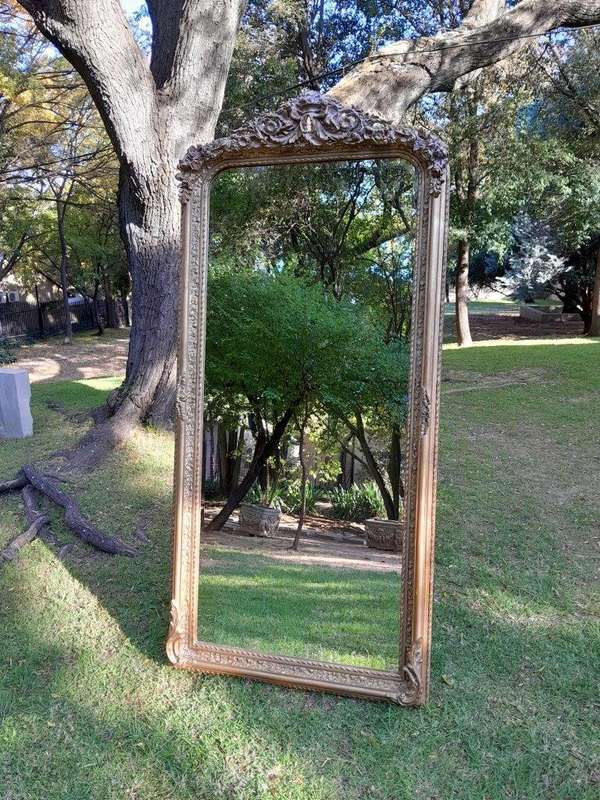 A French Rococo Style Ornately Carved & Gilded Bevelled Mirror